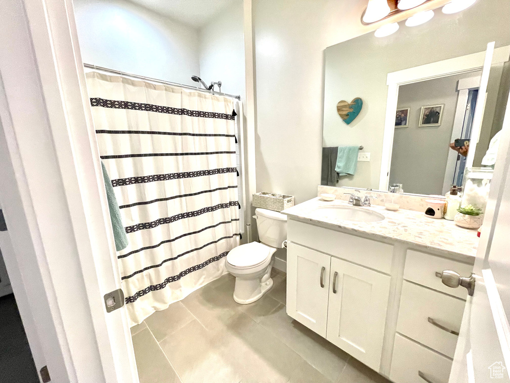 Bathroom with vanity, tile patterned flooring, and toilet