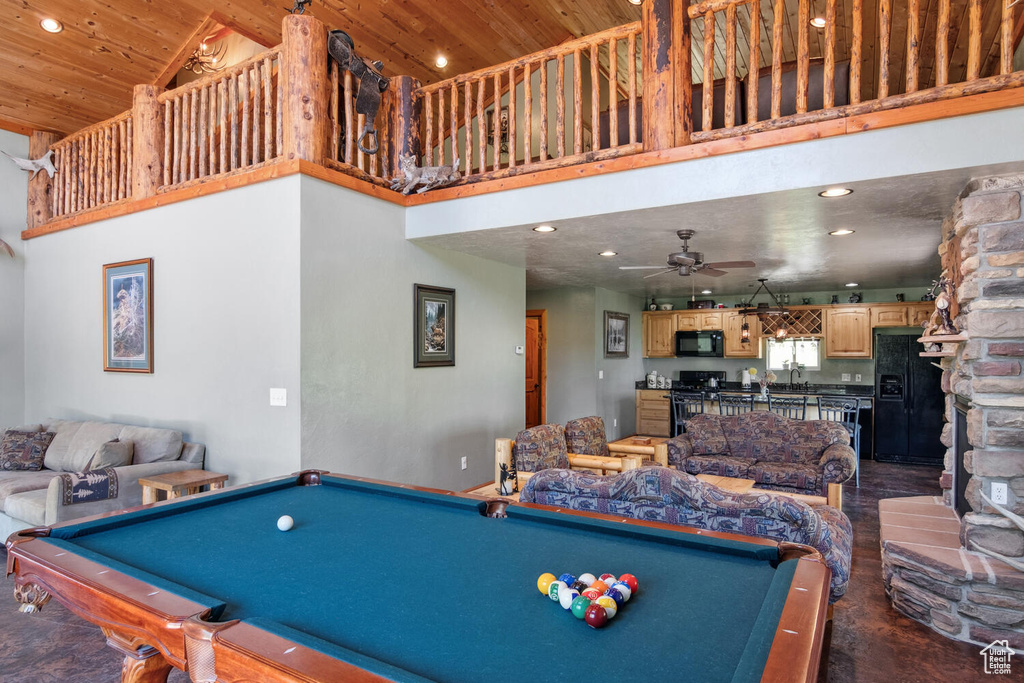 Rec room with a stone fireplace, ceiling fan, wood ceiling, high vaulted ceiling, and pool table