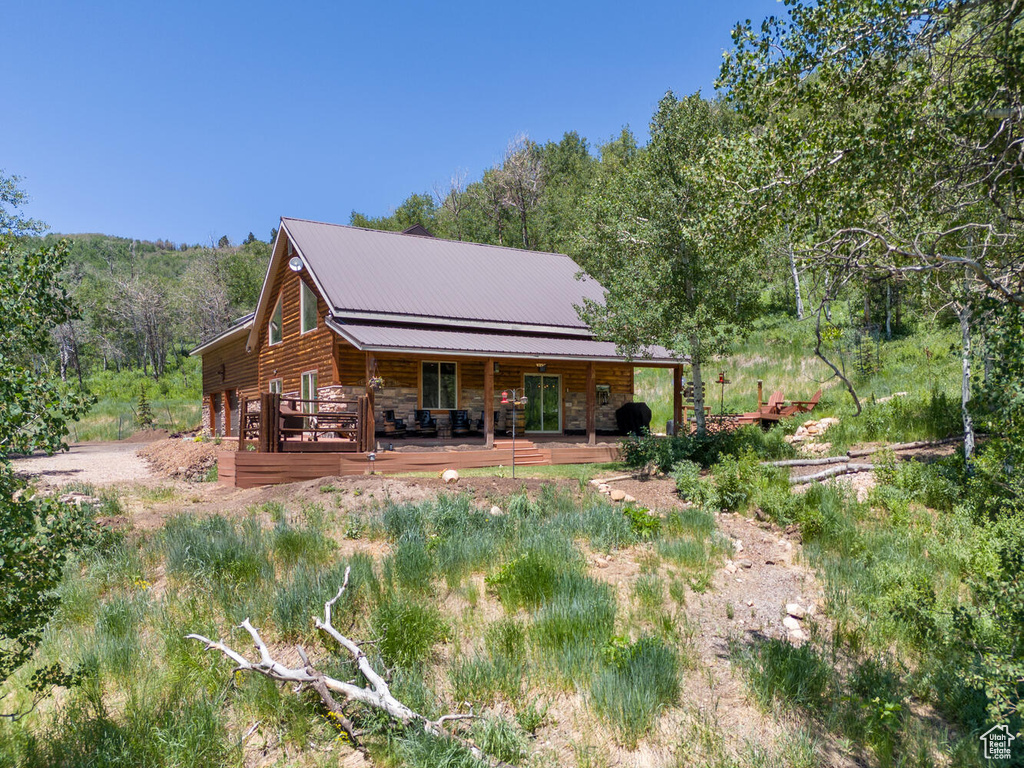 Rear view of house featuring a wooden deck