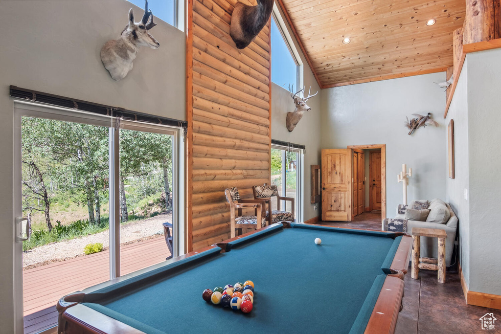 Playroom with high vaulted ceiling, pool table, rustic walls, and wood ceiling