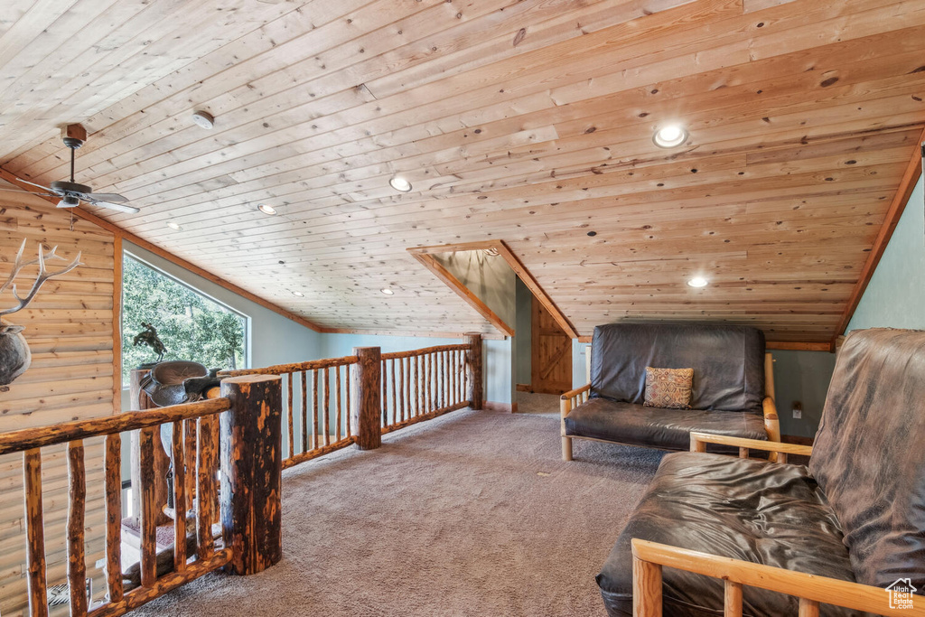 Unfurnished room featuring ceiling fan, vaulted ceiling, carpet flooring, and wood ceiling