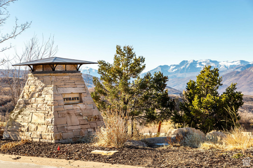 Community / neighborhood sign with a mountain view