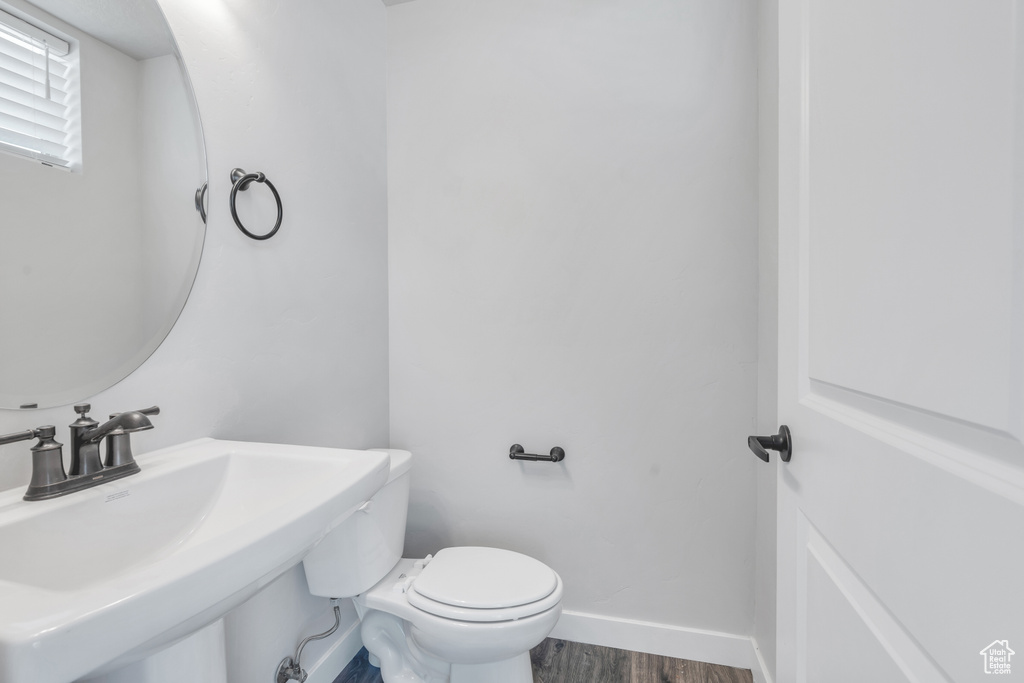 Bathroom with sink, wood-type flooring, and toilet