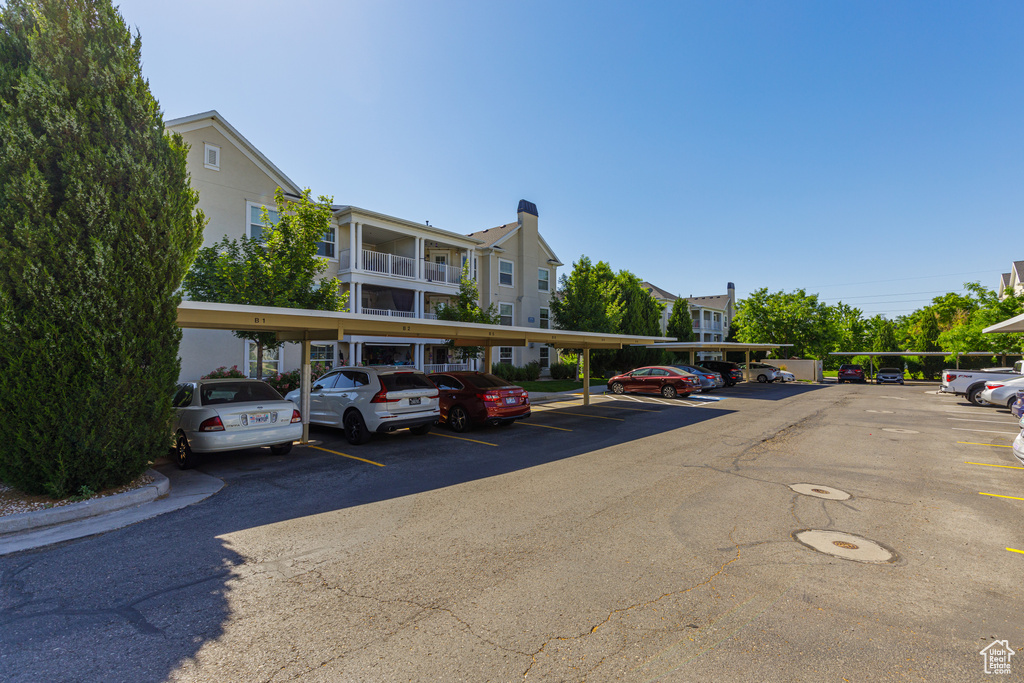 View of parking featuring a carport