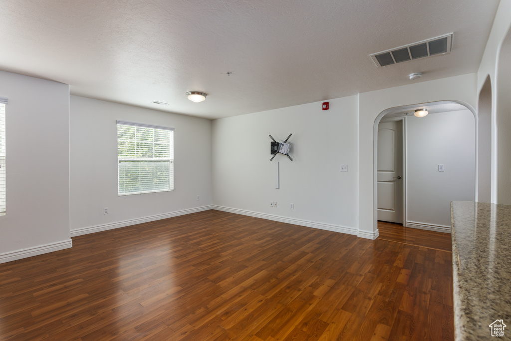 Unfurnished room with dark hardwood / wood-style floors