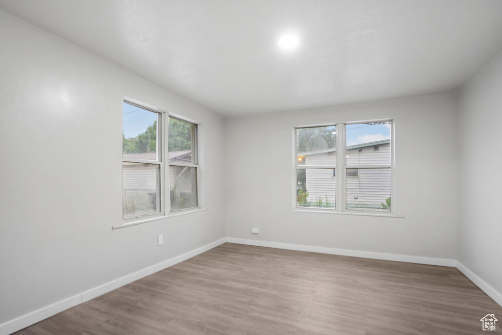 Empty room with hardwood / wood-style floors