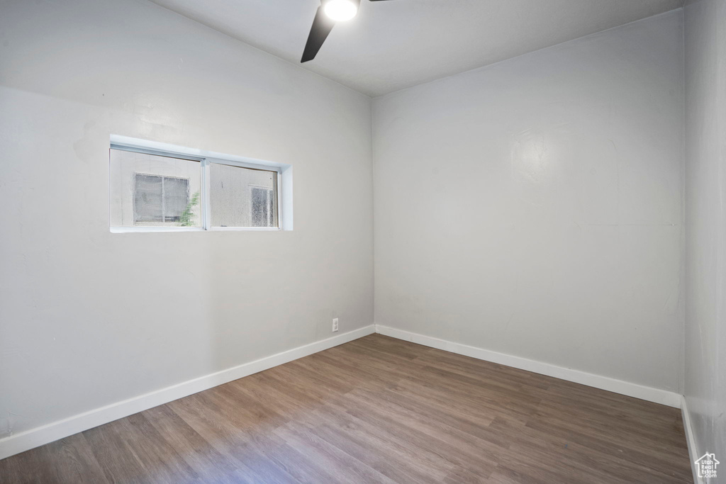 Unfurnished room with ceiling fan and wood-type flooring