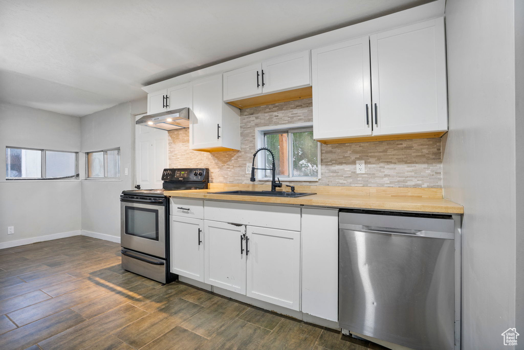 Kitchen with dishwasher, sink, tasteful backsplash, and electric range oven