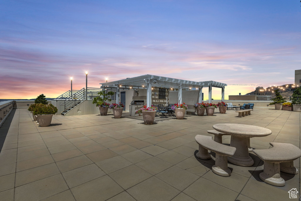 Patio terrace at dusk with a pergola