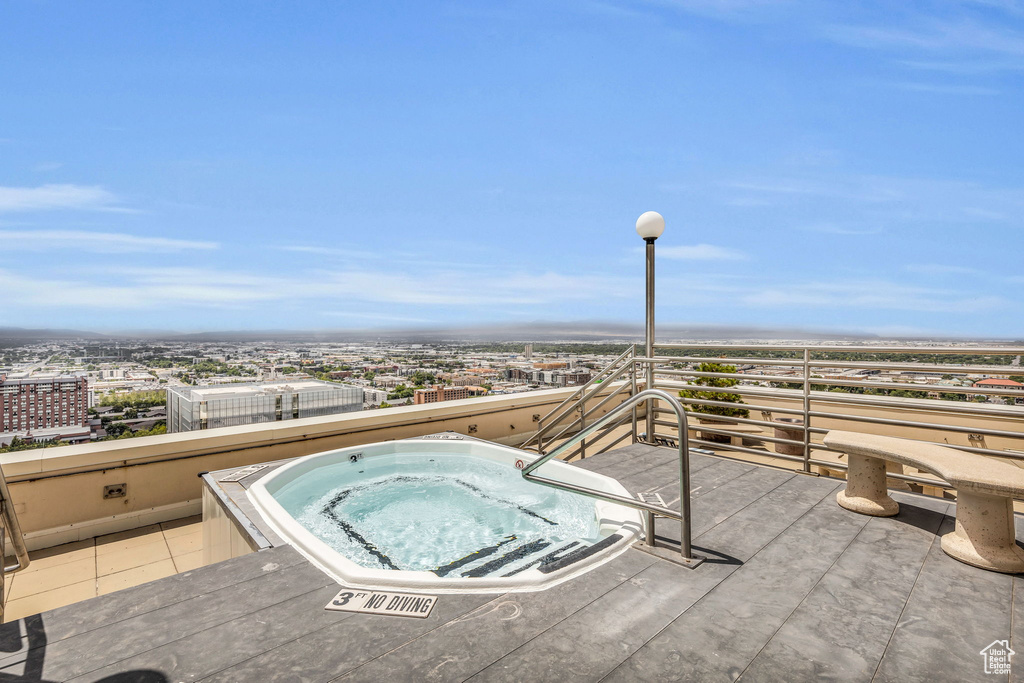 View of swimming pool featuring an in ground hot tub