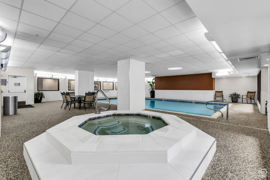 View of swimming pool featuring an indoor in ground hot tub