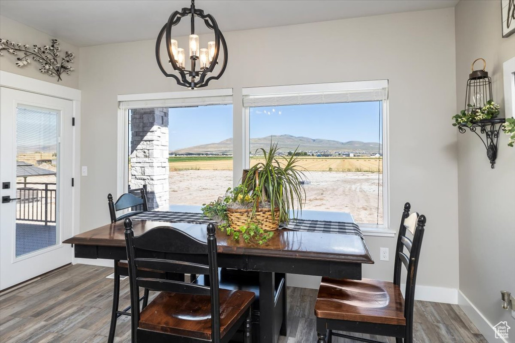 Dining space featuring a chandelier, dark hardwood / wood-style floors, and a mountain view