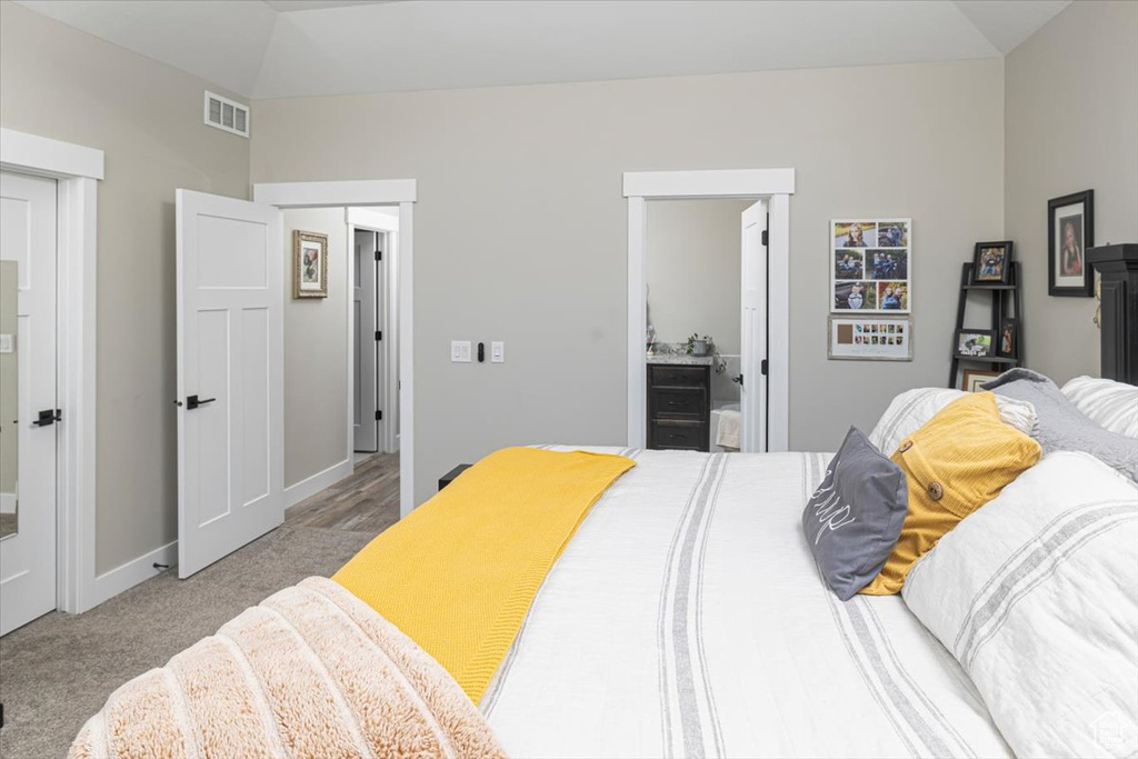 Bedroom featuring carpet floors and lofted ceiling