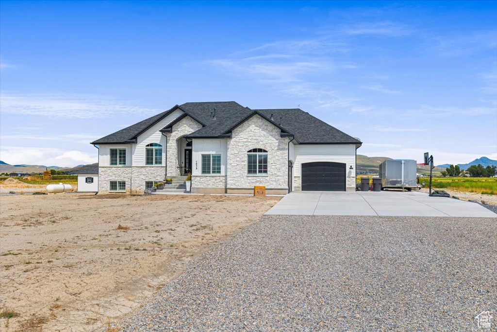 French country home featuring a garage