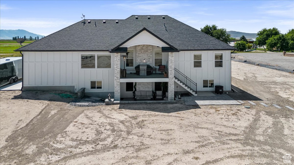 Back of property with a mountain view