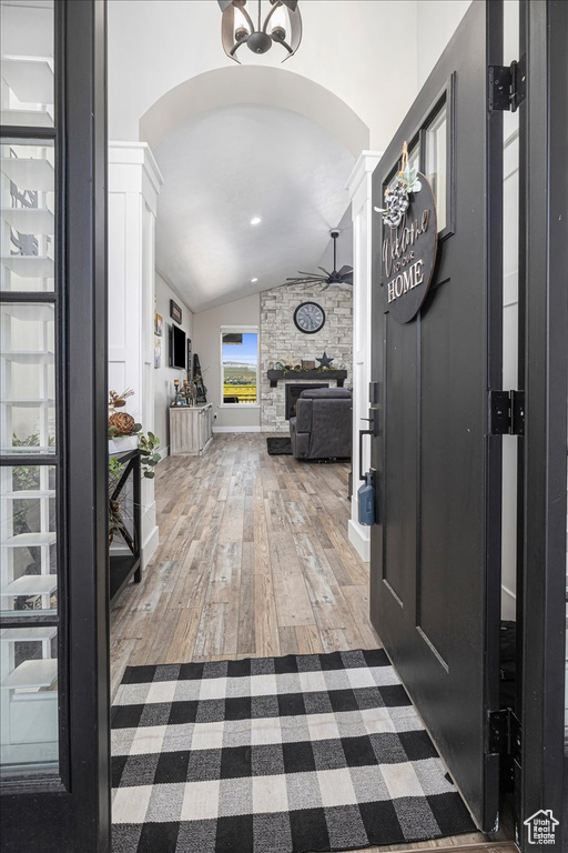 Entryway with ornate columns, lofted ceiling, ceiling fan, and hardwood / wood-style floors