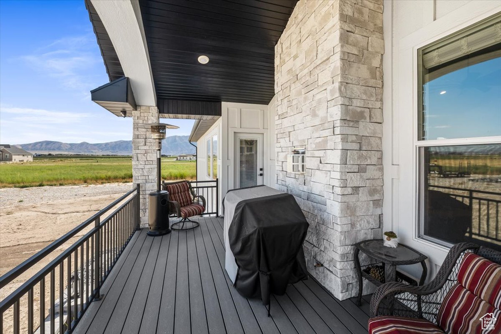 Wooden deck with a mountain view and grilling area