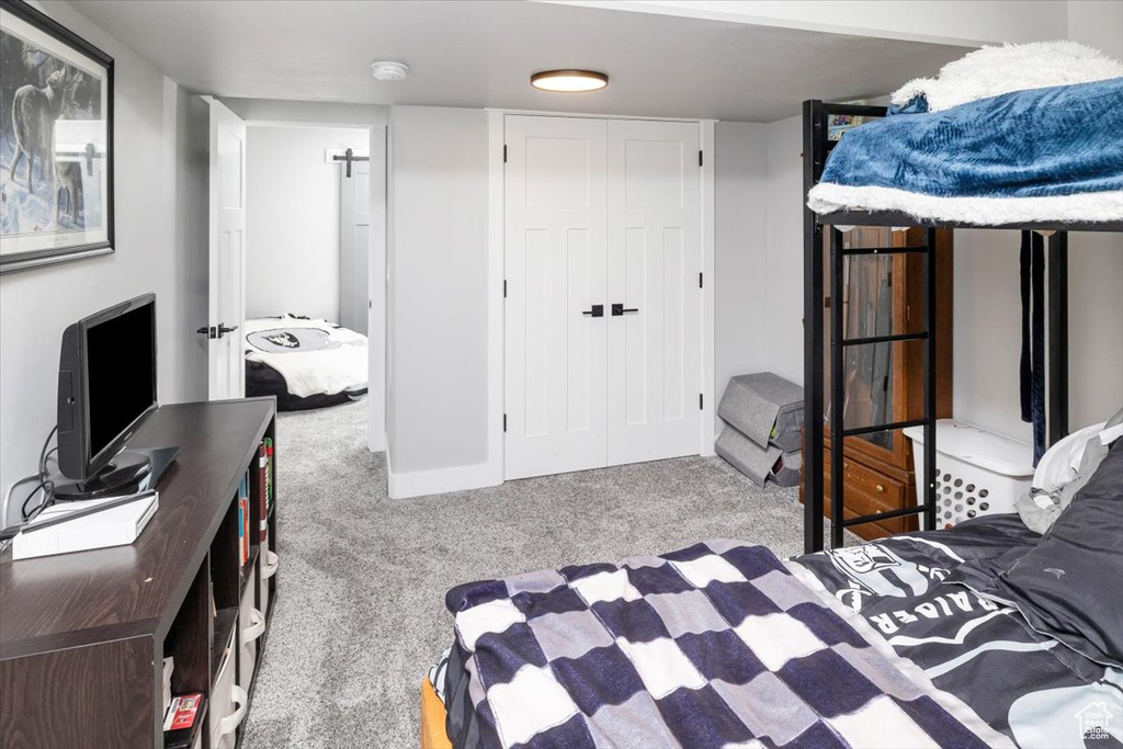 Bedroom with a closet and light carpet