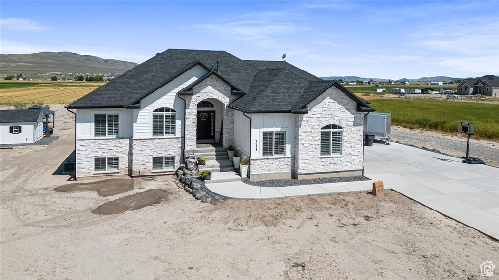 French provincial home with a patio area and a mountain view