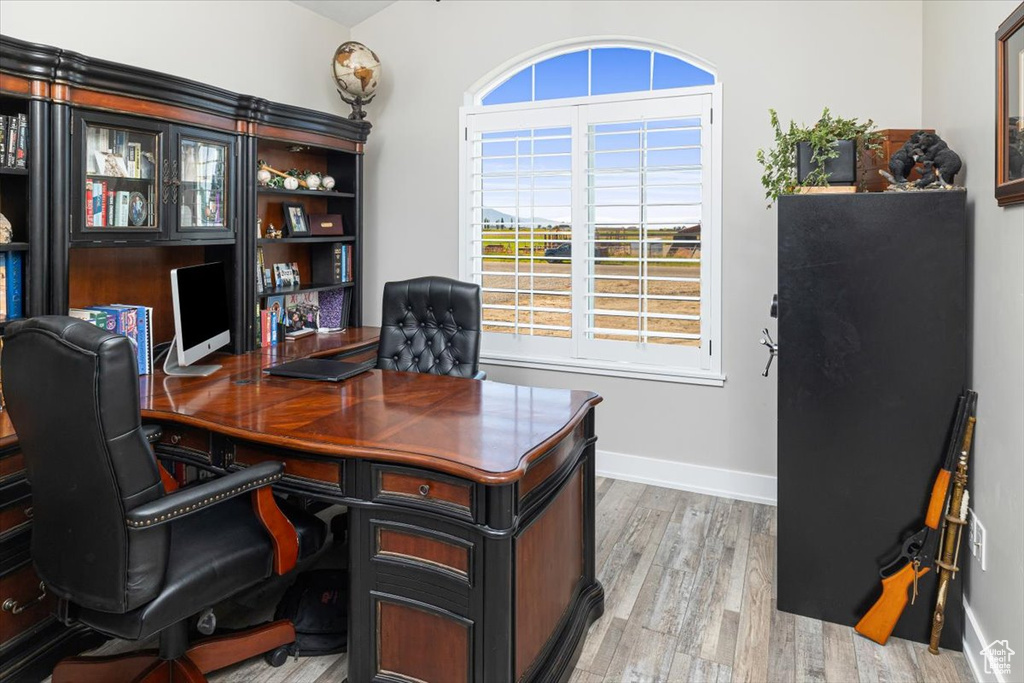 Home office with hardwood / wood-style floors