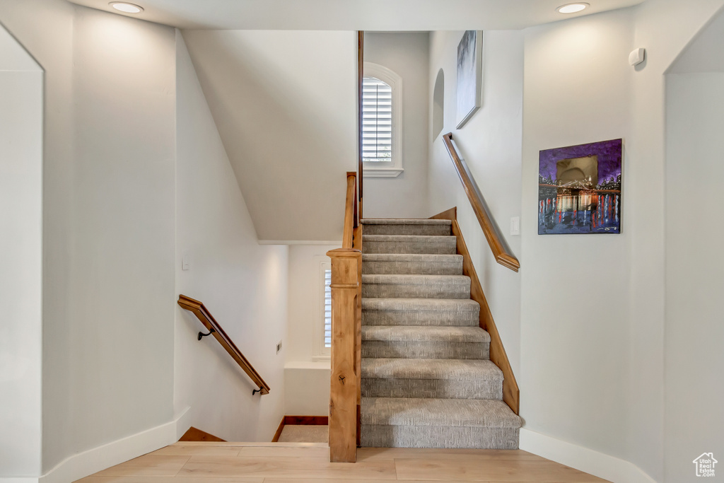 Stairway featuring hardwood / wood-style floors