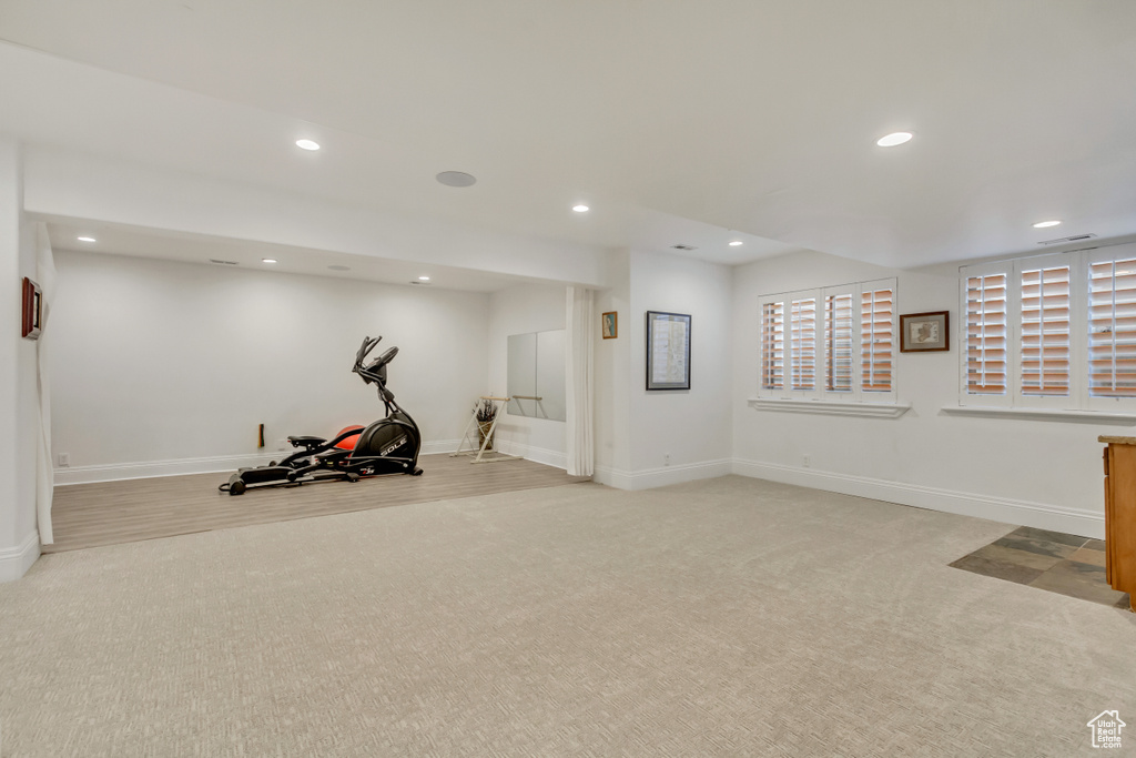 Exercise room featuring light carpet