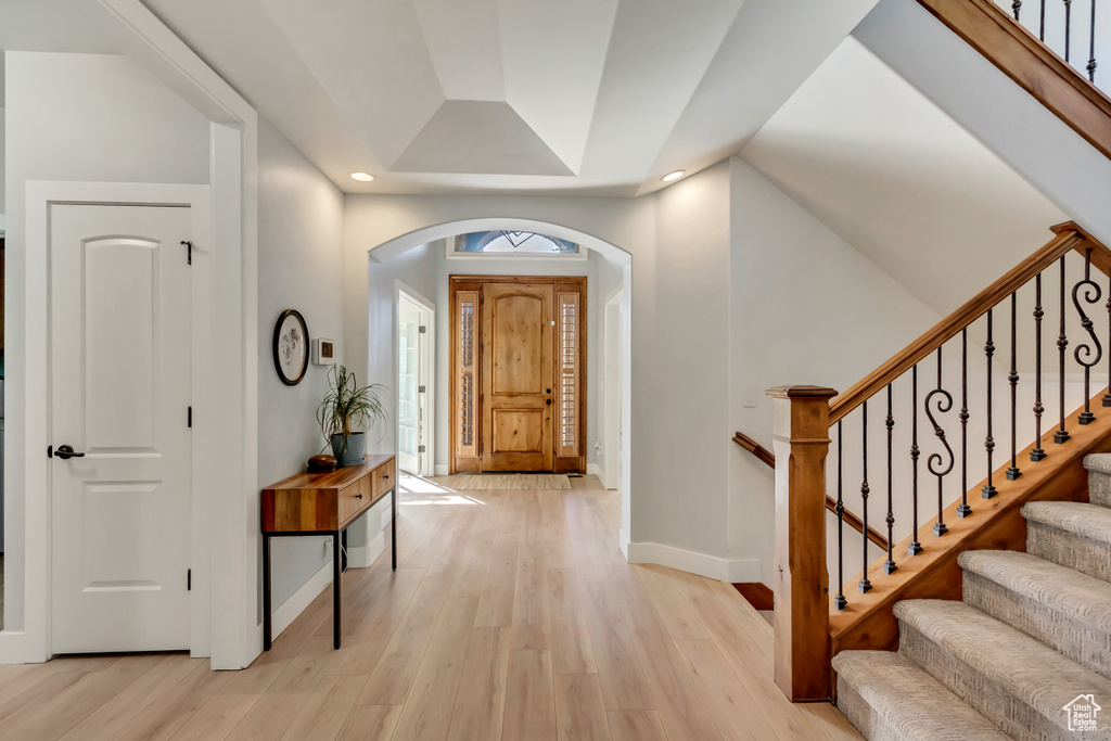 Foyer entrance with light wood-type flooring