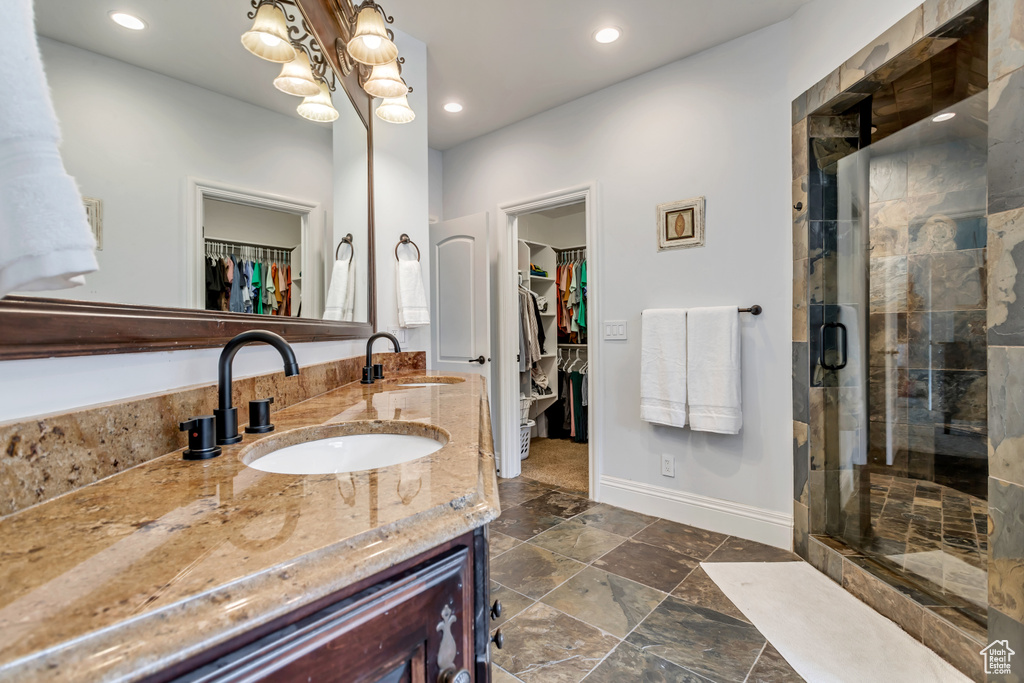 Bathroom featuring vanity and an enclosed shower