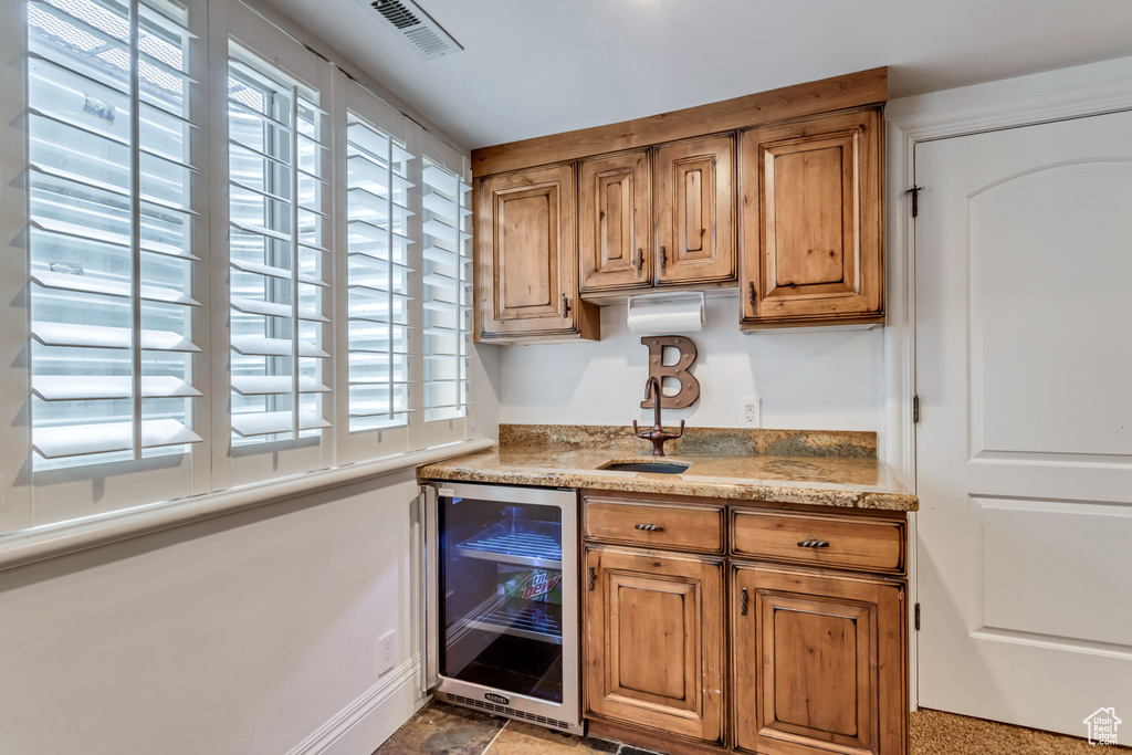 Kitchen with a healthy amount of sunlight and beverage cooler