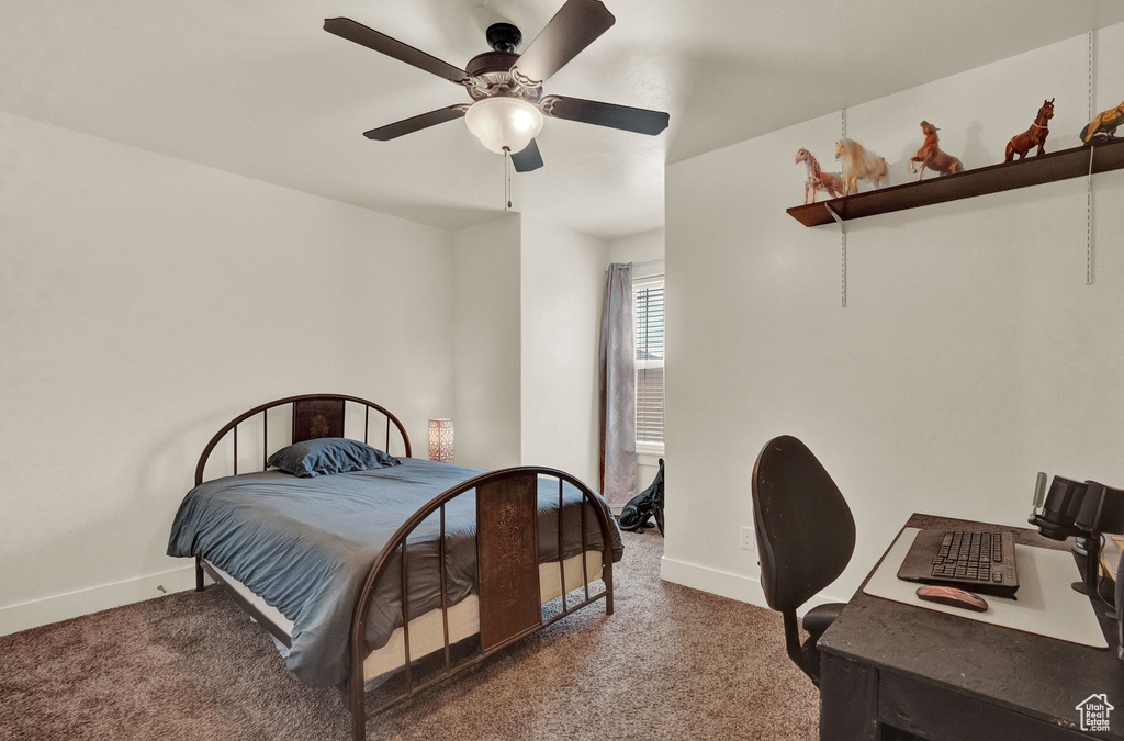 Carpeted bedroom featuring ceiling fan