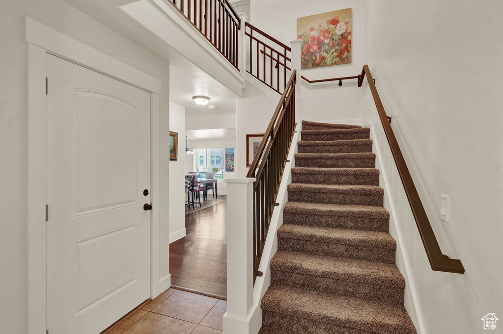 Stairs featuring light tile floors