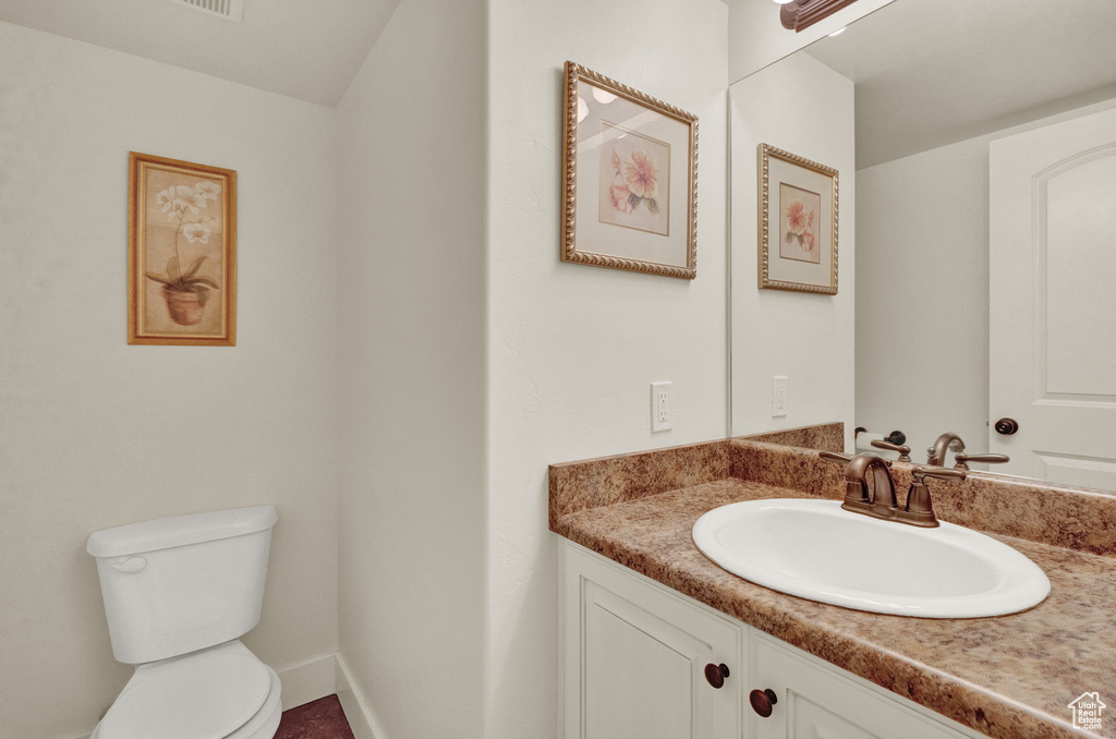 Bathroom featuring vanity and toilet