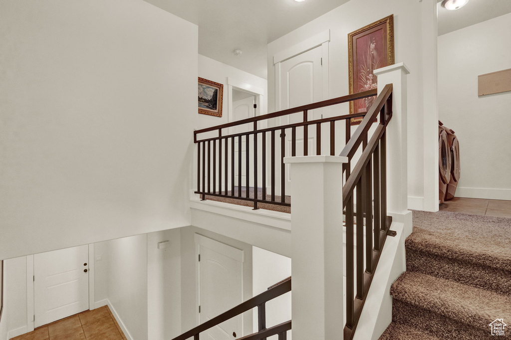 Stairs with light tile flooring