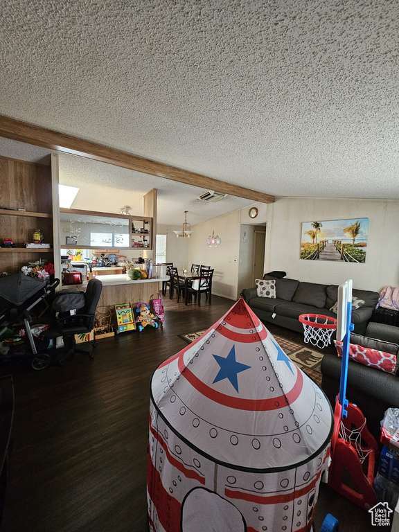 Living room featuring hardwood / wood-style flooring and a textured ceiling