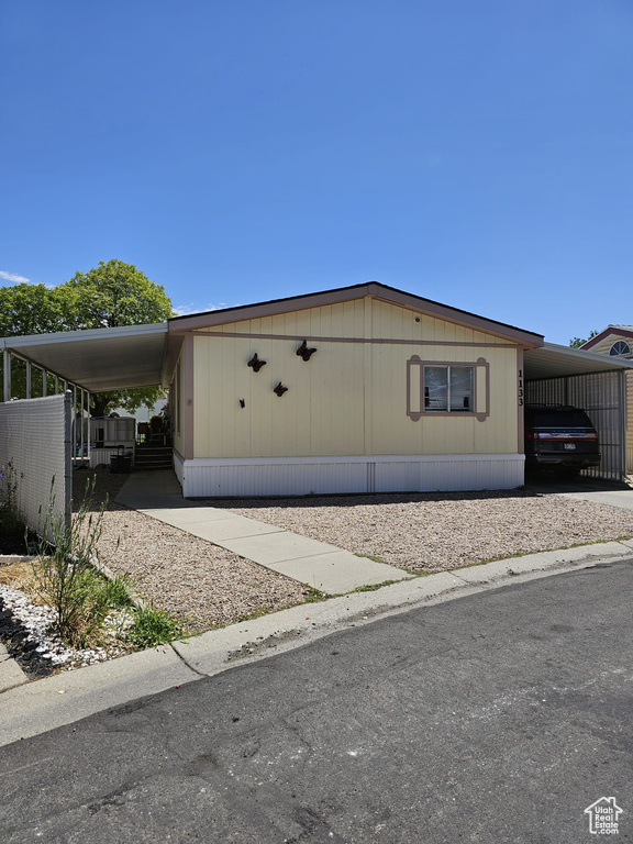 View of side of property with a carport