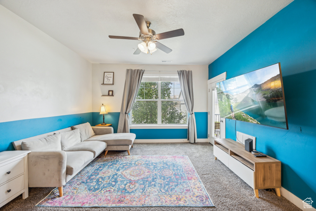 Living room featuring carpet flooring and ceiling fan