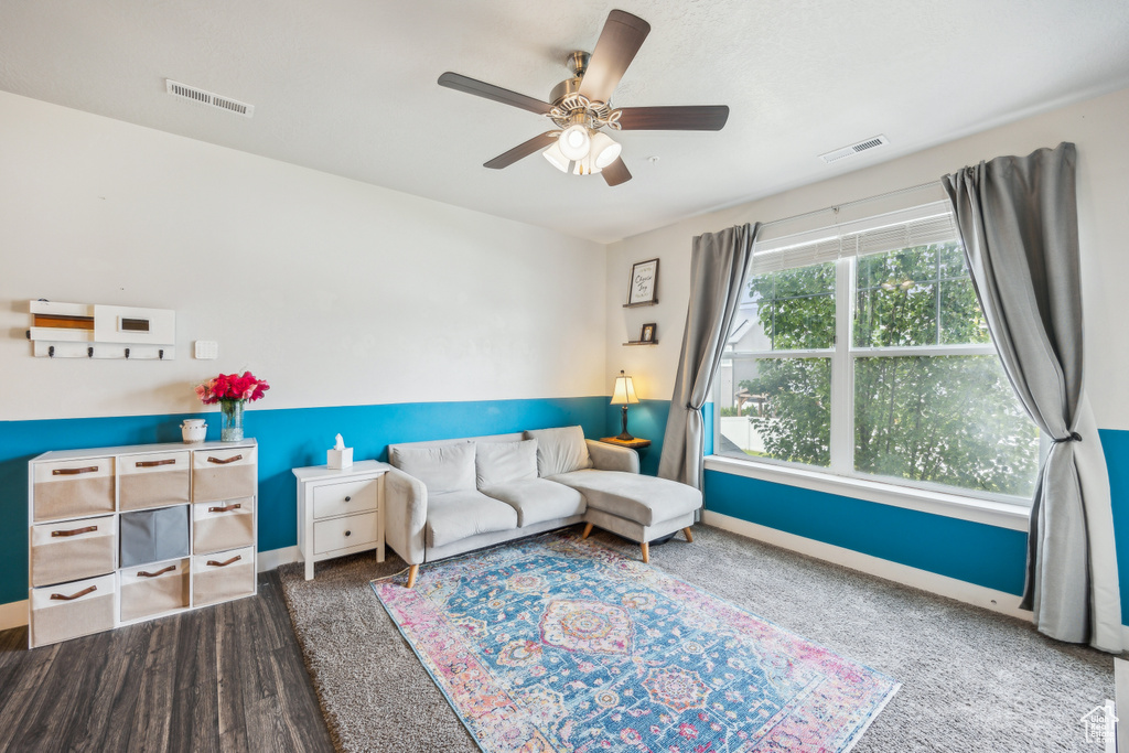 Interior space featuring ceiling fan and dark hardwood / wood-style flooring