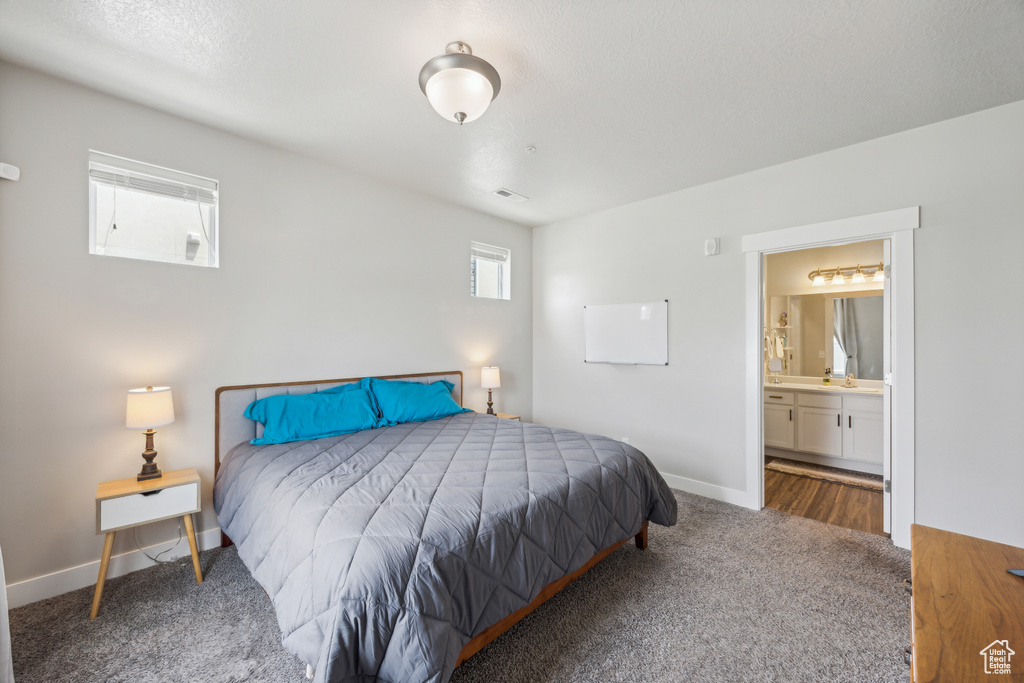 Carpeted bedroom with ensuite bath