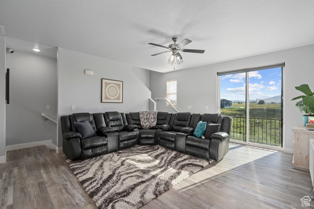 Living room with hardwood / wood-style floors and ceiling fan