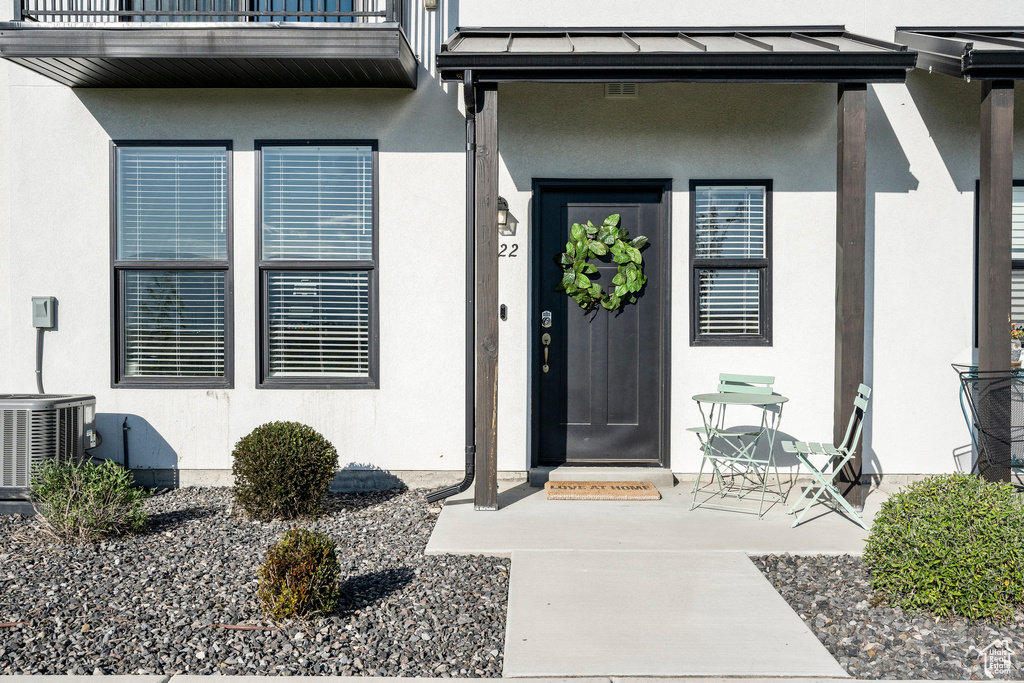 Property entrance with central AC and a balcony