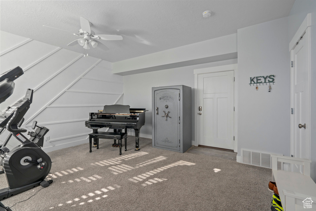 Miscellaneous room featuring ceiling fan and carpet floors