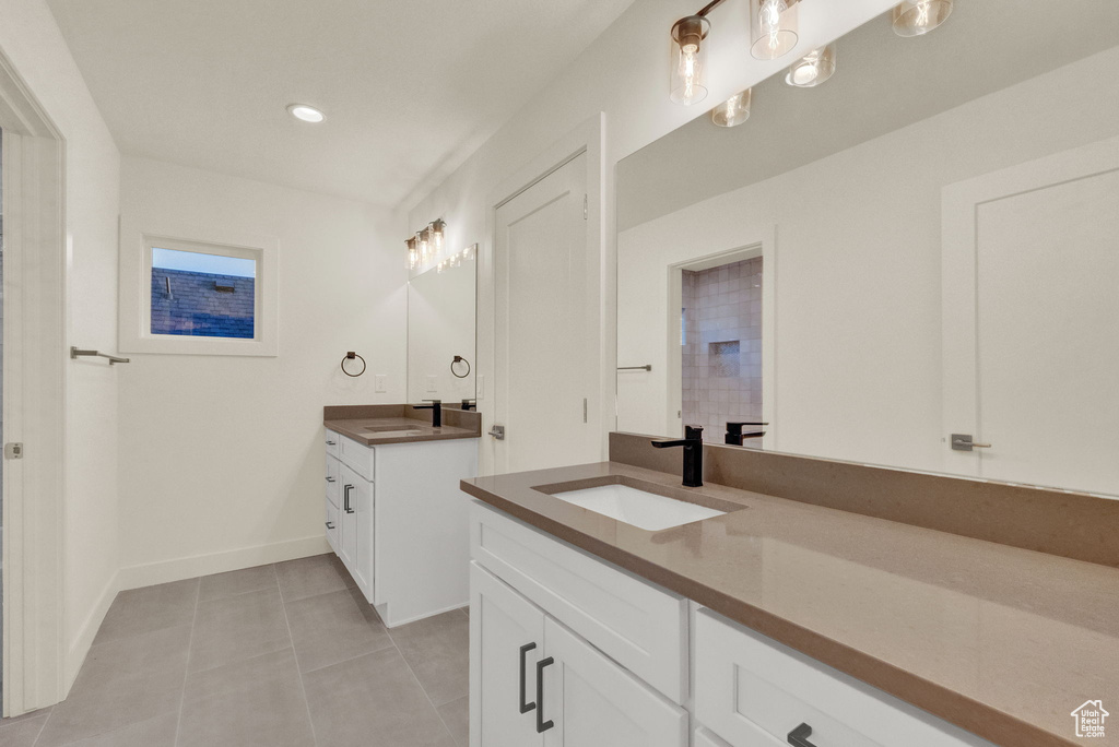 Bathroom featuring tile flooring and double vanity