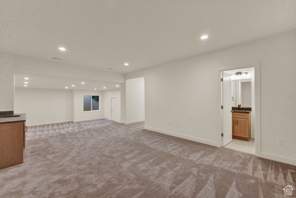 Unfurnished living room with light colored carpet