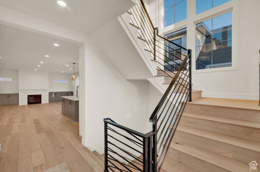 Stairway featuring light hardwood / wood-style flooring