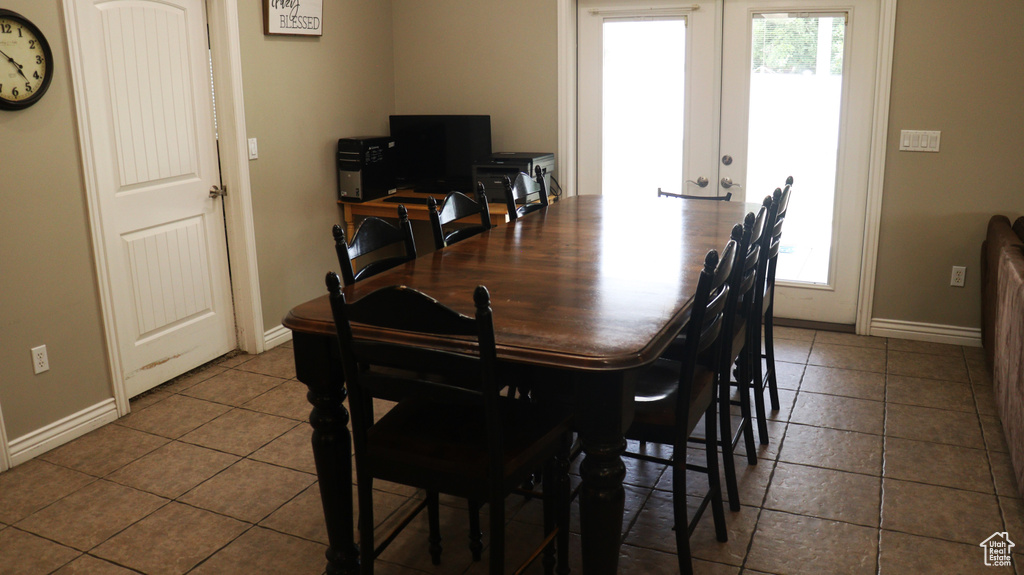 Tiled dining space with french doors and a wealth of natural light