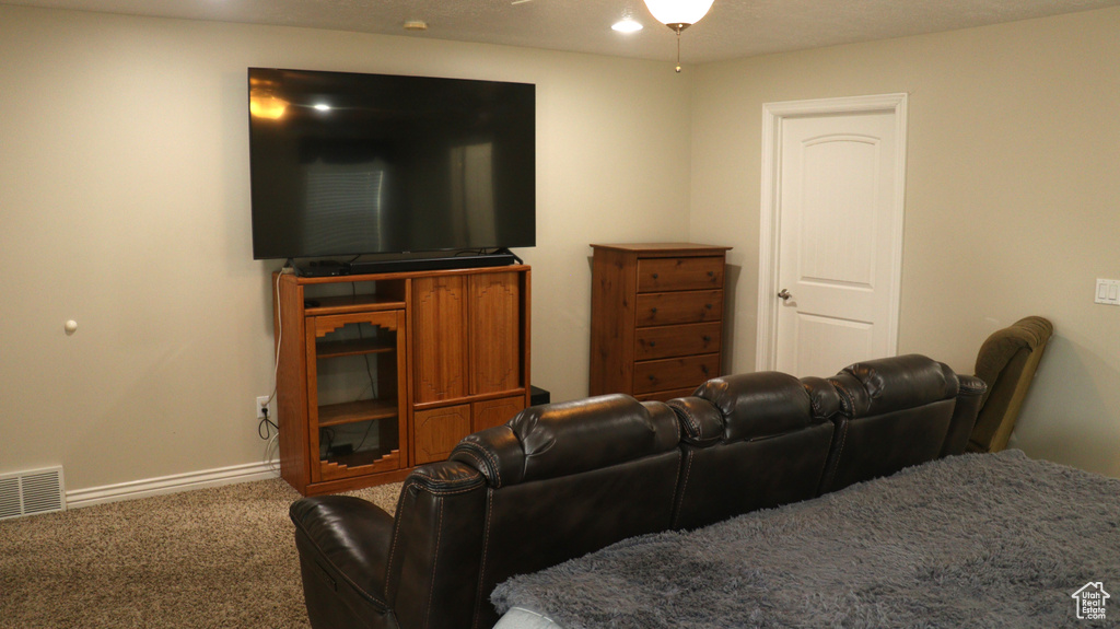 Living room featuring carpet flooring and ceiling fan