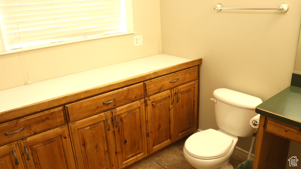 Bathroom with tile flooring, toilet, and vanity