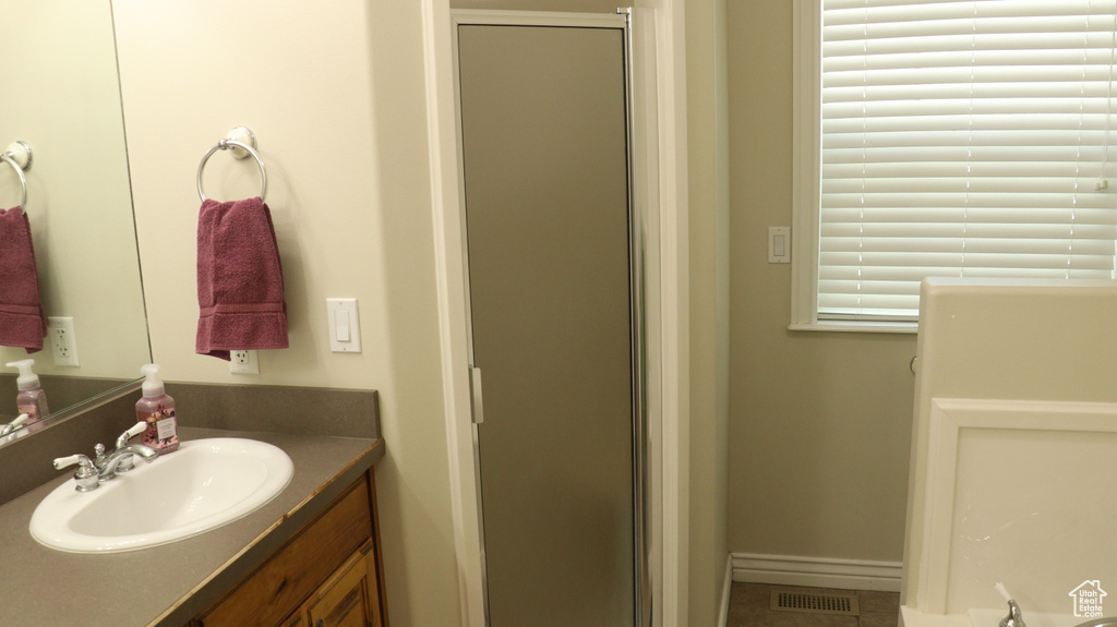 Bathroom featuring tile flooring and vanity