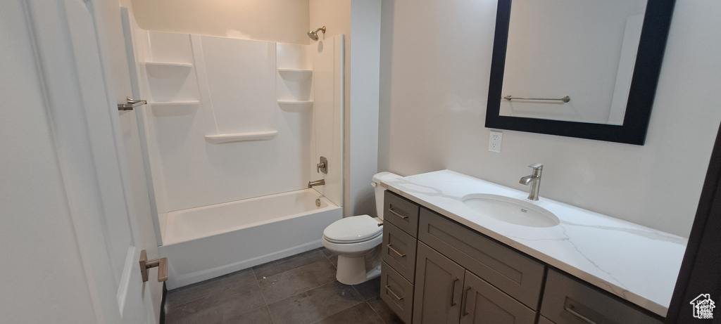 Full bathroom featuring tile floors, shower / washtub combination, toilet, and vanity