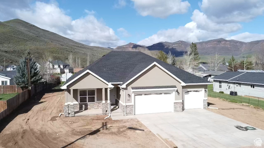 View of front of property featuring a garage and a mountain view